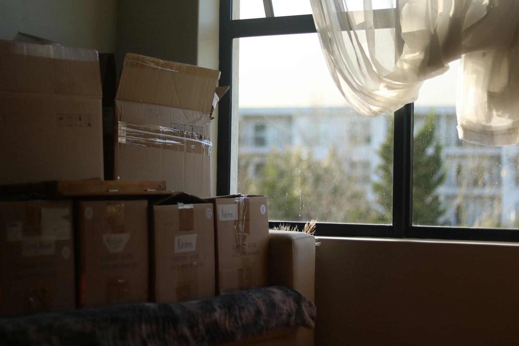Packed moving boxes in a bright home